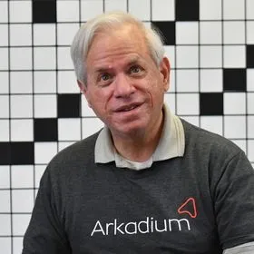 A picture of Puzzle Master Stan Newman wearing an Arkadium T-shirt