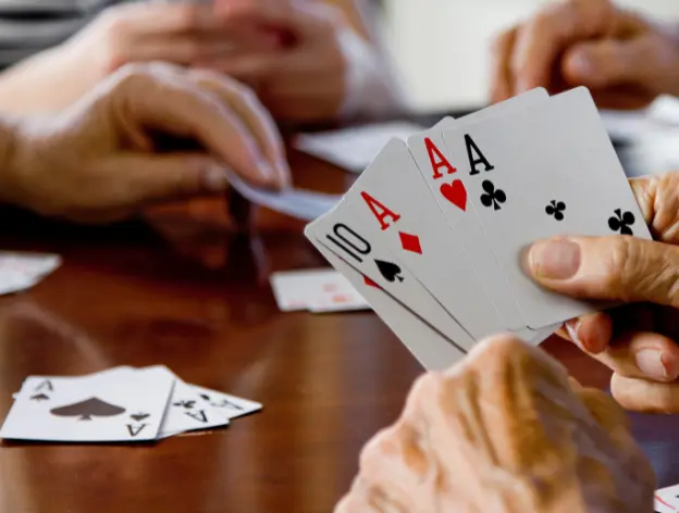 Group of people playing the card game “Euchre”