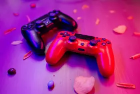 A photo of two game controllers sitting on a coffee table